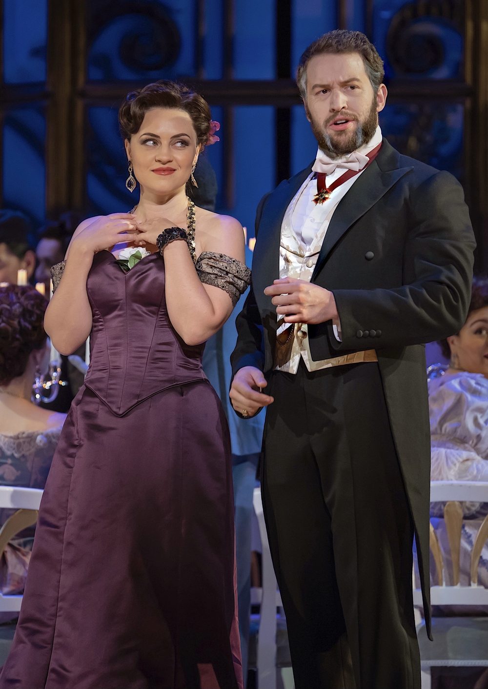 Michael Hewitt in white tie beside a soprano in a purple gown, in La traviata with Washington National Opera